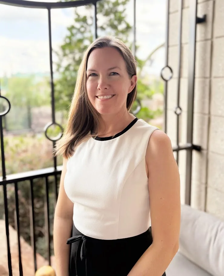 Amanda Maucere smiling by a bright window